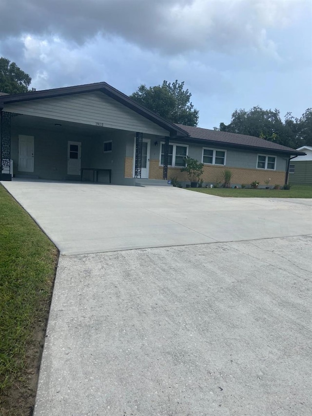 ranch-style house featuring a carport