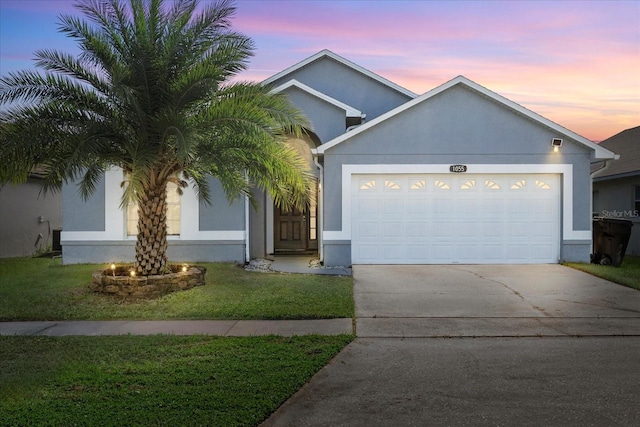 view of front facade with a lawn and a garage