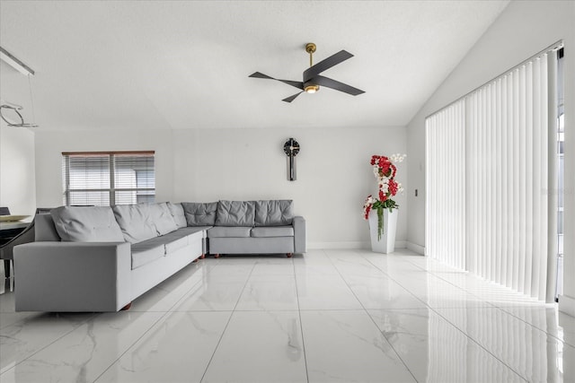 living room featuring a textured ceiling, lofted ceiling, and ceiling fan