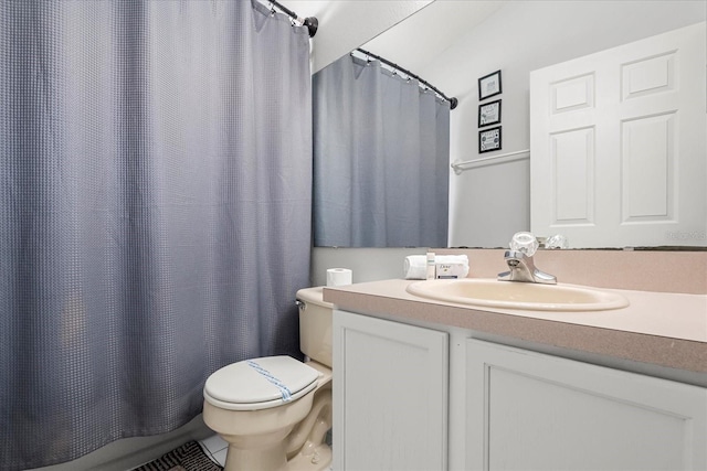 bathroom featuring tile patterned floors, curtained shower, vanity, and toilet