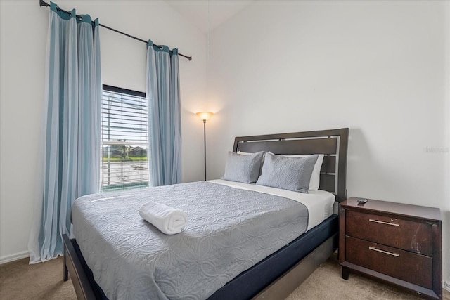 carpeted bedroom with vaulted ceiling