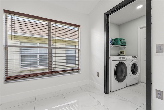 clothes washing area with washer and clothes dryer