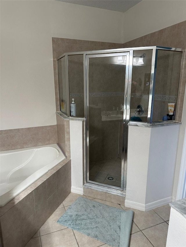 bathroom with tile patterned floors and separate shower and tub