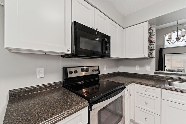 kitchen with white cabinetry, electric stove, a textured ceiling, decorative light fixtures, and a notable chandelier