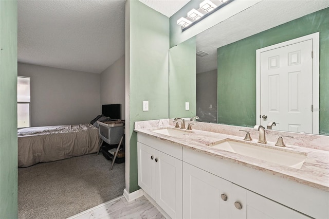 bathroom with vanity and a textured ceiling