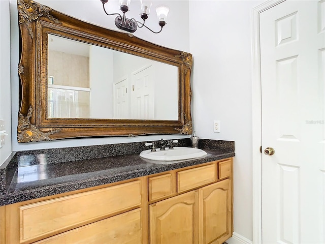 bathroom featuring vanity and a chandelier