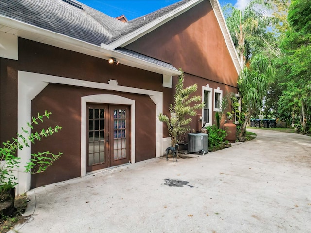 doorway to property with central AC unit and a patio area