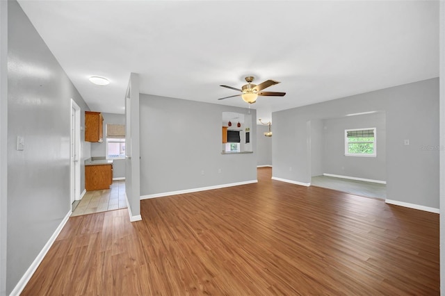 unfurnished living room featuring light wood-type flooring and ceiling fan