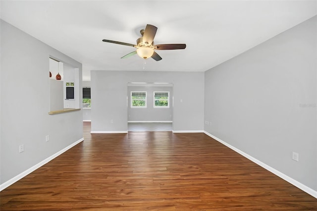 empty room with dark wood-type flooring and ceiling fan