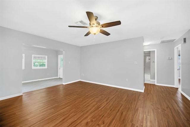 unfurnished room with dark hardwood / wood-style flooring and ceiling fan