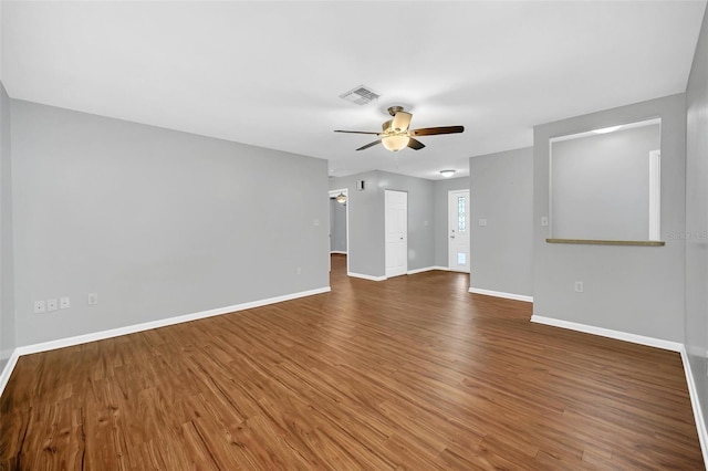 spare room featuring ceiling fan and dark wood-type flooring