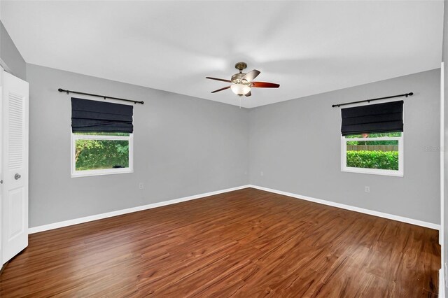 empty room with ceiling fan and wood-type flooring