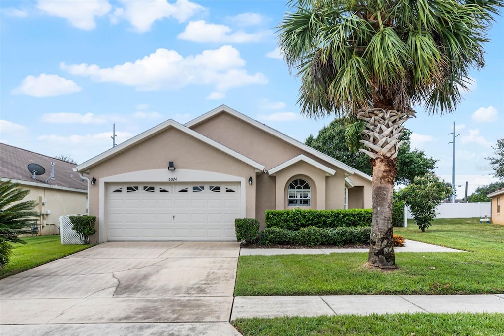 ranch-style home featuring a front lawn and a garage