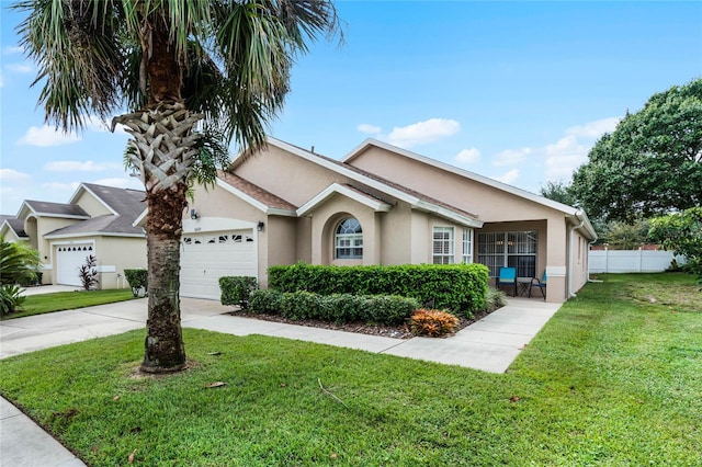 ranch-style home featuring a garage and a front yard