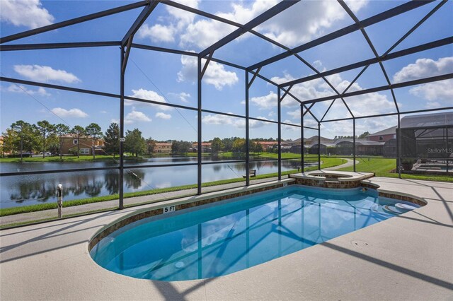 view of pool featuring an in ground hot tub, a patio, glass enclosure, and a water view