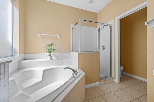 bathroom with shower with separate bathtub, toilet, and tile patterned floors