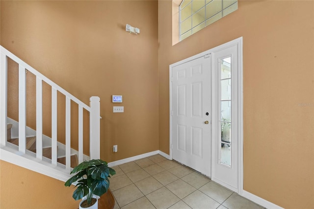 foyer entrance with tile patterned floors and a healthy amount of sunlight