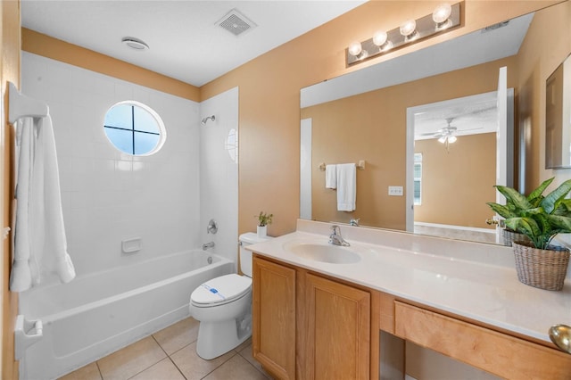 full bathroom with vanity, tiled shower / bath combo, tile patterned flooring, ceiling fan, and toilet