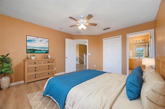 bedroom featuring ceiling fan, a textured ceiling, a closet, and light hardwood / wood-style floors