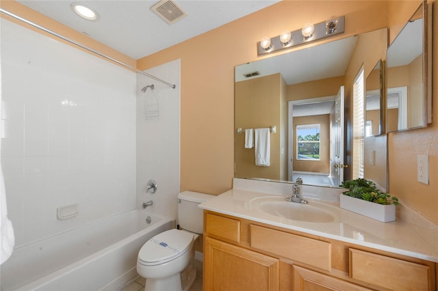 full bathroom with tiled shower / bath combo, vanity, and toilet