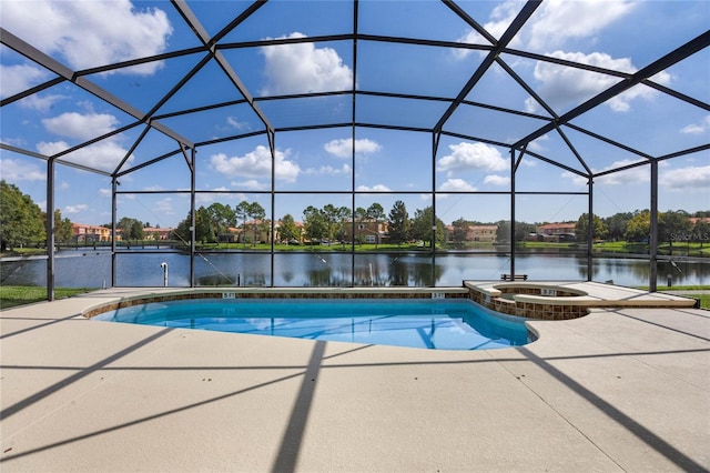 view of pool featuring glass enclosure, a water view, and a patio area