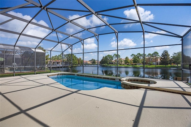 view of pool featuring glass enclosure, a water view, an in ground hot tub, and a patio area