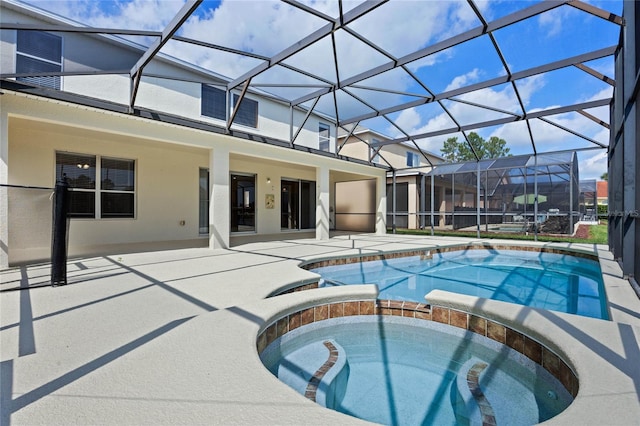 view of swimming pool with a lanai, a patio, and an in ground hot tub