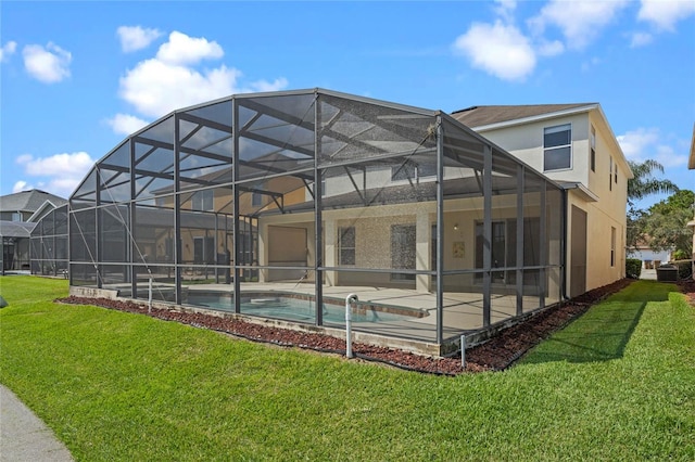 rear view of house with a yard, a lanai, central AC, and a patio area