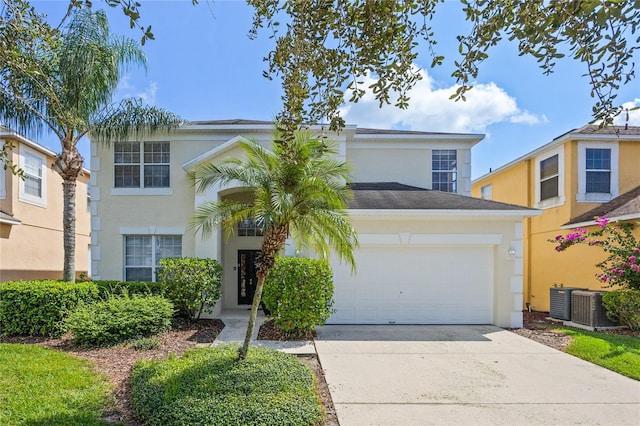 view of front of property with central AC unit and a garage