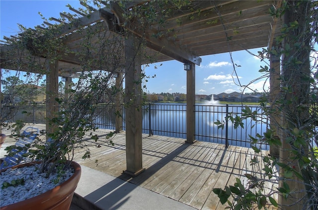 wooden deck featuring a pergola and a water view