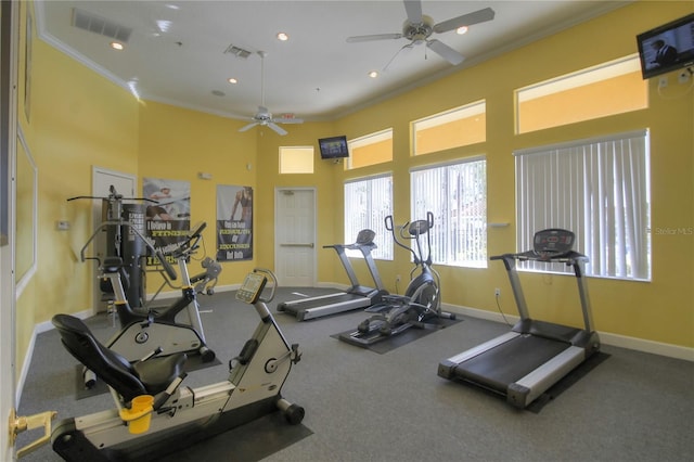 exercise room with ceiling fan and crown molding