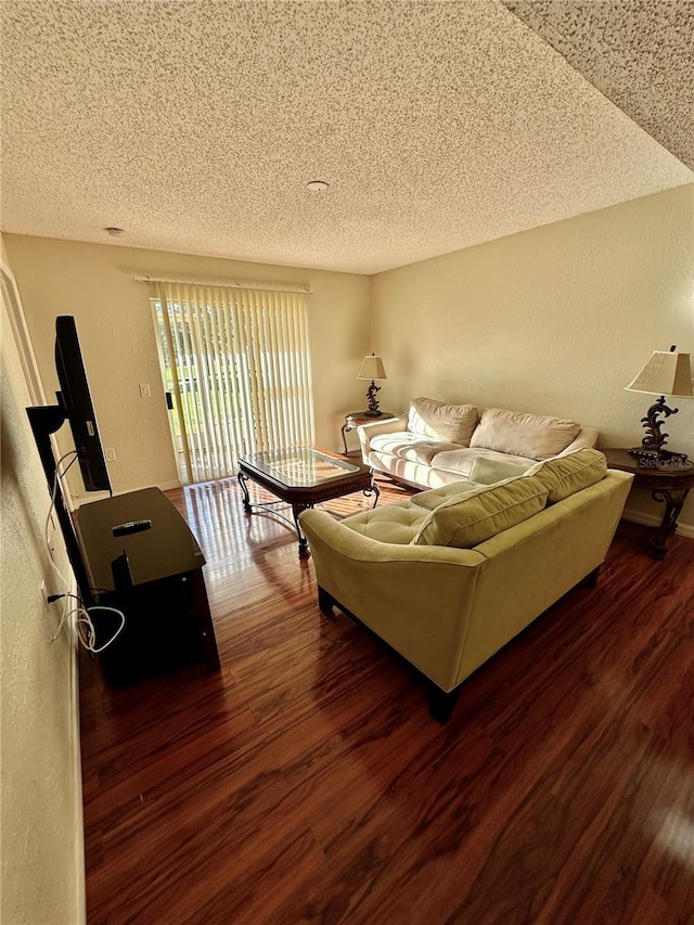 living room with a textured ceiling and dark wood-type flooring