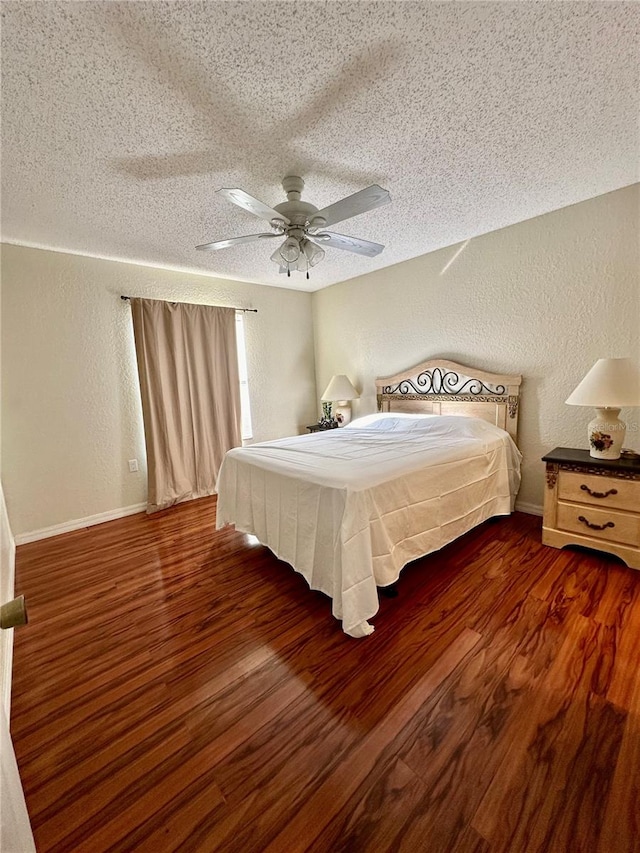 bedroom featuring dark hardwood / wood-style floors, a textured ceiling, and ceiling fan