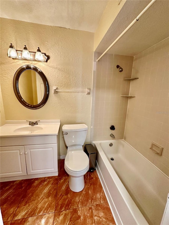 full bathroom featuring vanity, toilet, tiled shower / bath combo, and a textured ceiling