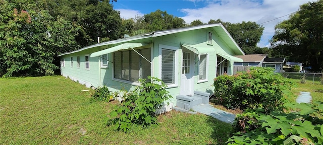 view of side of home with a lawn