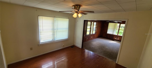 empty room with dark wood-type flooring and ceiling fan