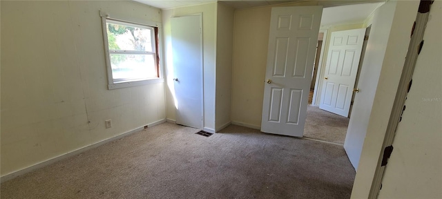 unfurnished bedroom featuring light colored carpet