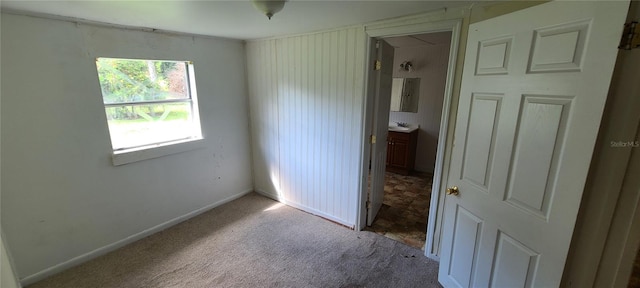 carpeted spare room featuring sink