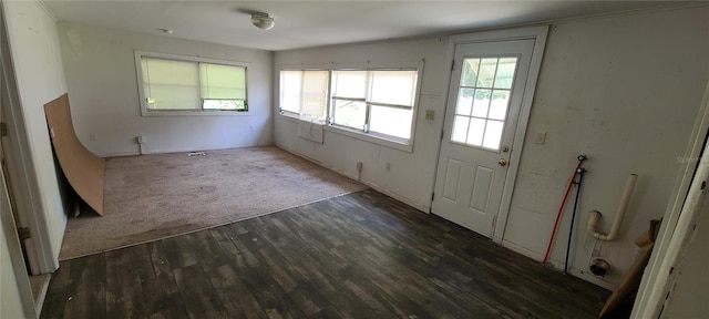 foyer featuring dark wood-type flooring and vaulted ceiling