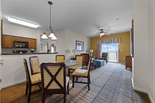 dining area with ceiling fan with notable chandelier