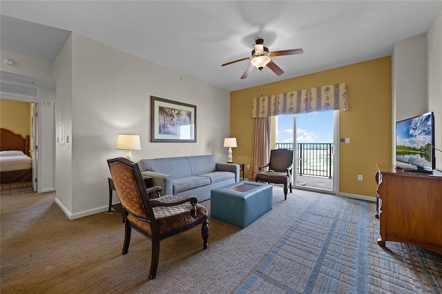 living room featuring ceiling fan and carpet flooring