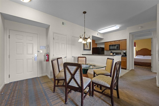 carpeted dining space with a notable chandelier