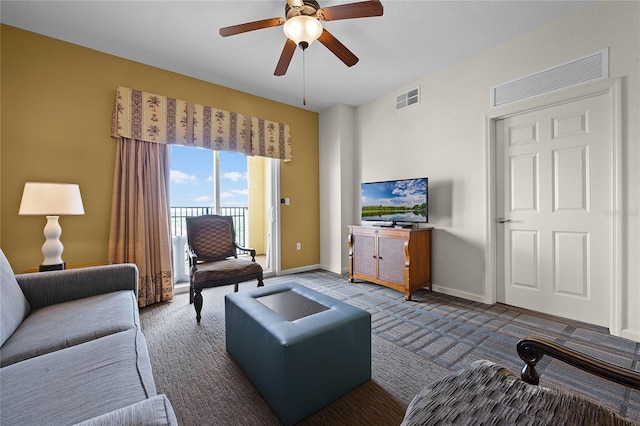 carpeted living room with ceiling fan