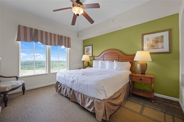 bedroom featuring dark colored carpet and ceiling fan