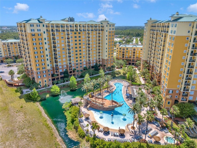 view of property with a water view and a community pool