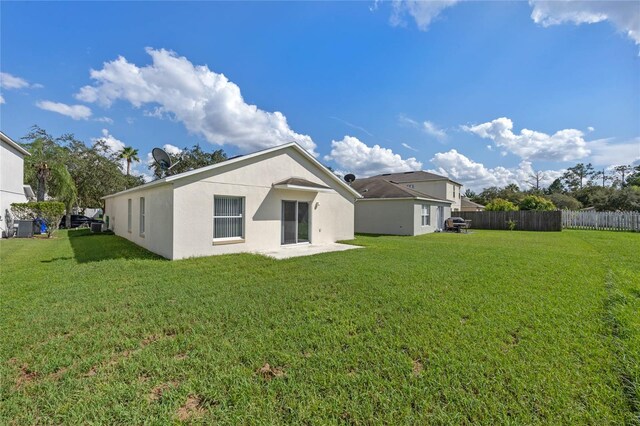 rear view of house featuring a yard