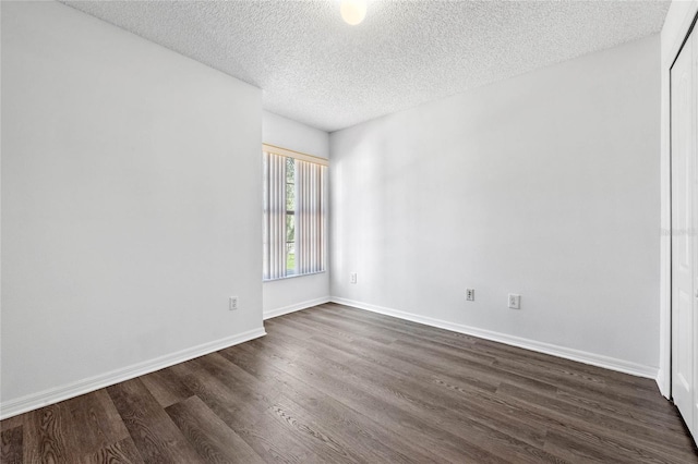 1548 Tiverton Blvd, Winter Garden, FL 34787 - spare room featuring baseboards, a textured ceiling, and dark wood-style floors
