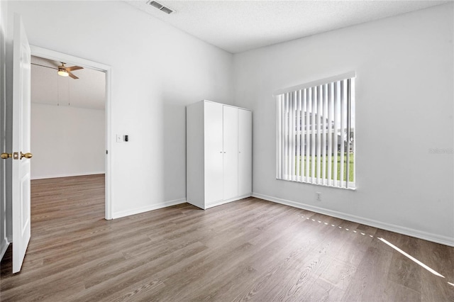1548 Tiverton Blvd, Winter Garden, FL 34787 - empty room with wood finished floors, baseboards, a ceiling fan, and visible vents
