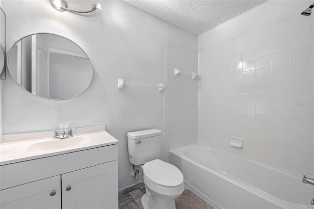 full bathroom with a textured ceiling, tiled shower / bath combo, vanity, and toilet