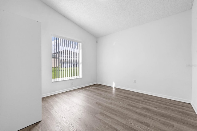1548 Tiverton Blvd, Winter Garden, FL 34787 - unfurnished room featuring dark wood-type flooring, a textured ceiling, baseboards, and lofted ceiling